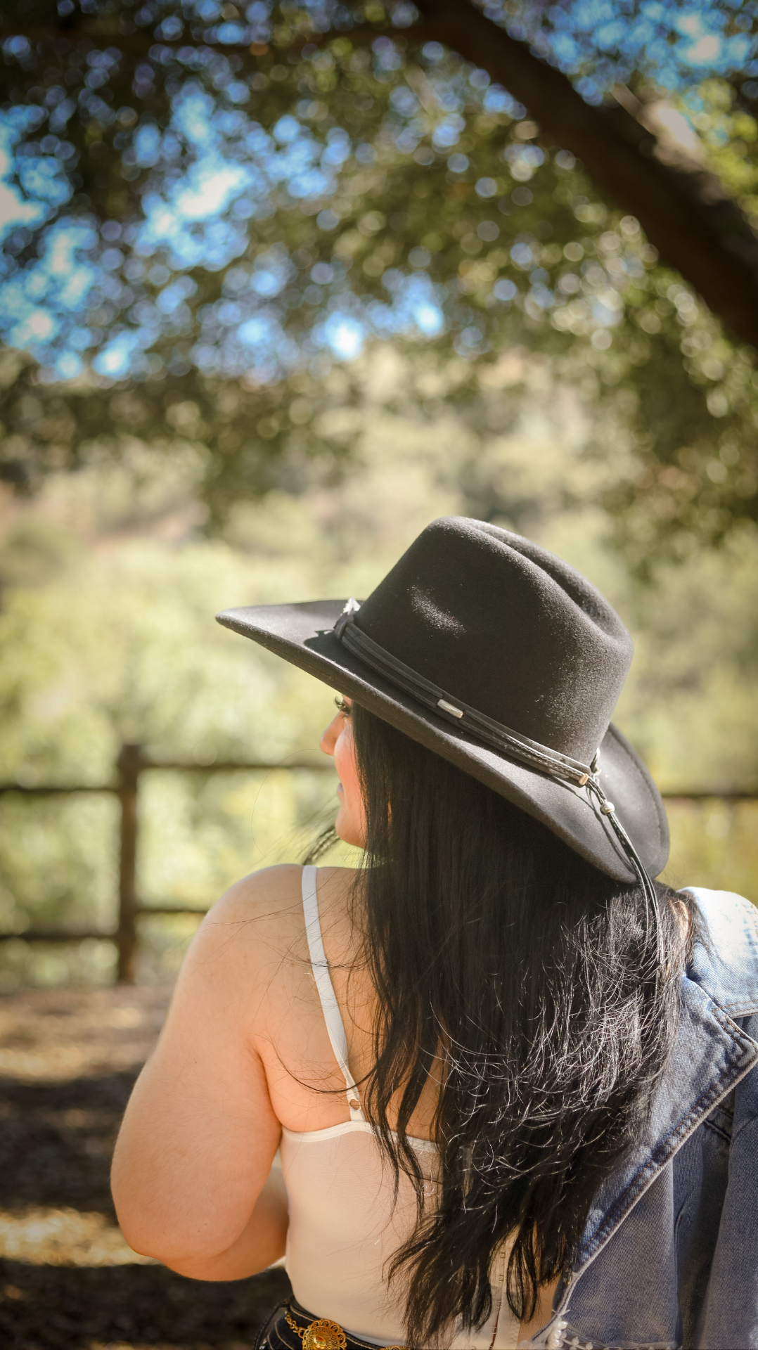 Cowgirl portrait under oak trees
