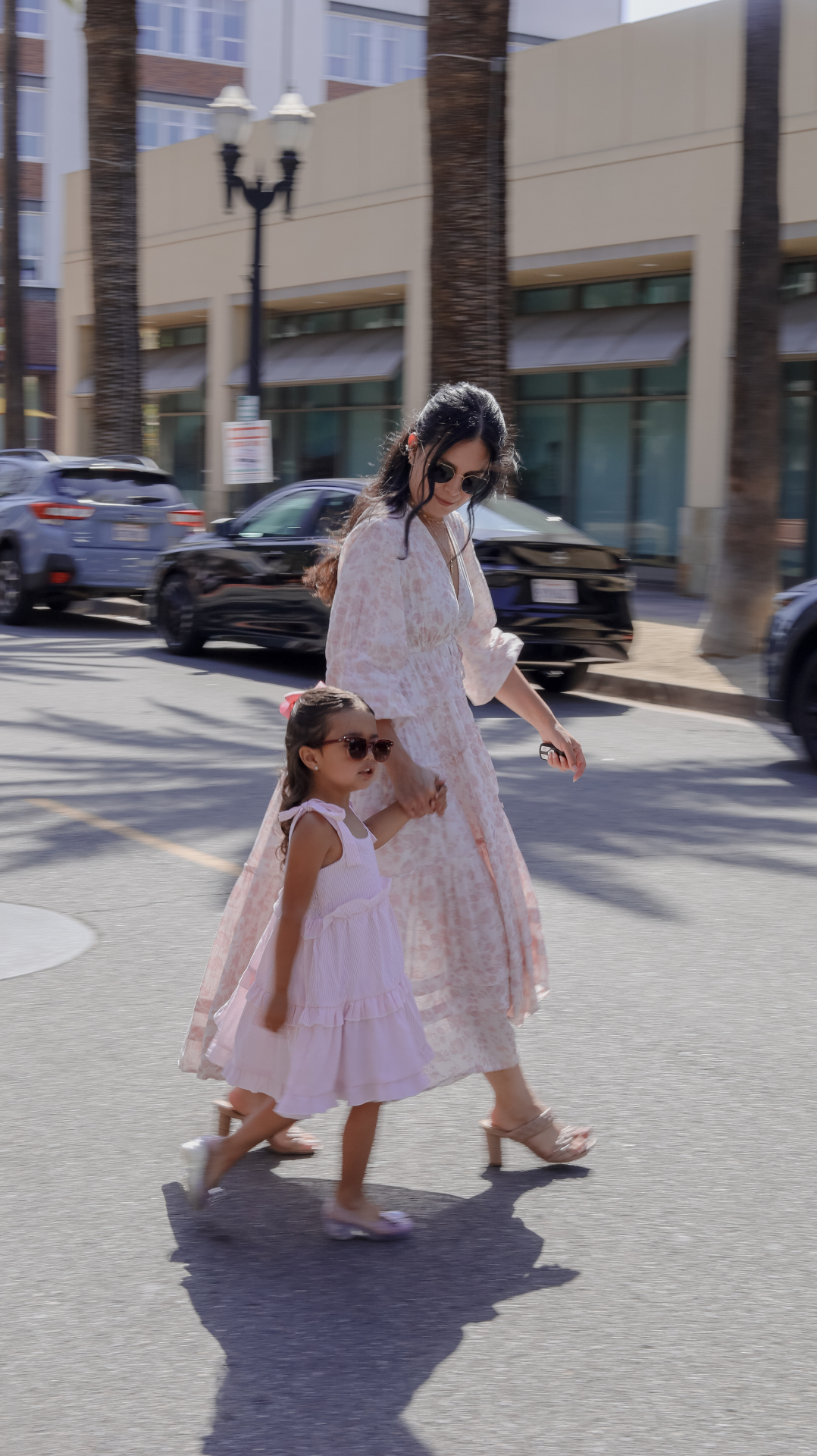 Mother and daughter walking in matching dresses