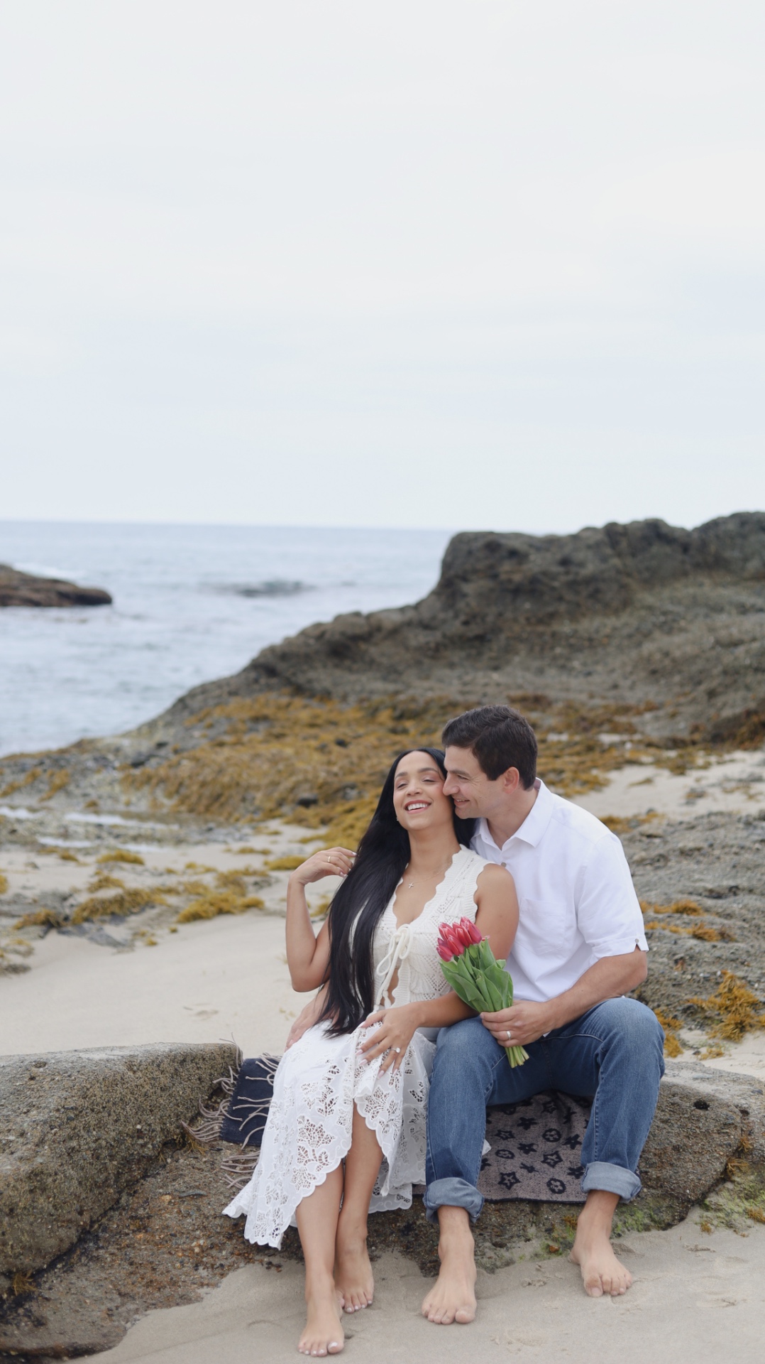 Couple laughing on the beach with tulips
